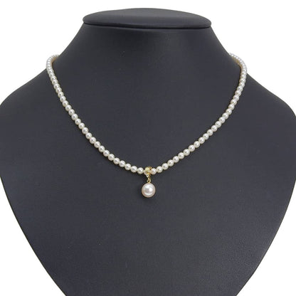 Tasaki pearl necklace with 18k yellow gold chain, freshwater Akoya pearls, and small melee diamonds