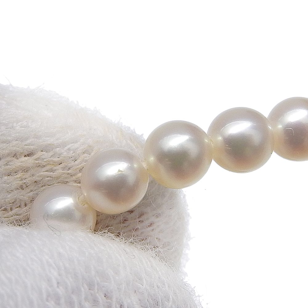 Tasaki pearl necklace with 18k yellow gold chain, freshwater Akoya pearls, and small melee diamonds