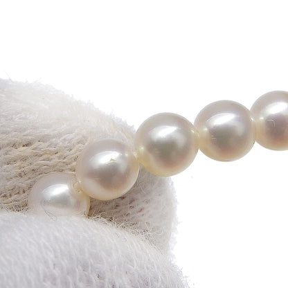 Tasaki pearl necklace with 18k yellow gold chain, freshwater Akoya pearls, and small melee diamonds