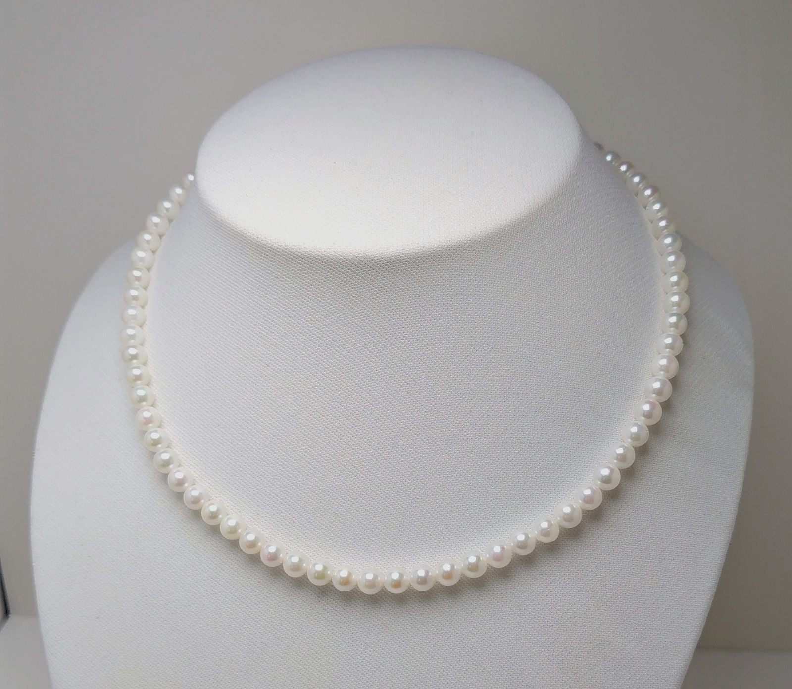 Akoya pearl necklace featuring round 5.5-6.0mm white, green, and pink pearls with good luster