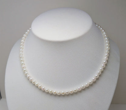 Akoya pearl necklace featuring round 5.5-6.0mm white, green, and pink pearls with good luster