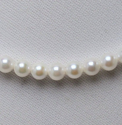 Akoya pearl necklace featuring round 5.5-6.0mm white, green, and pink pearls with good luster