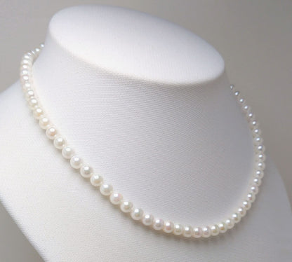 Akoya pearl necklace featuring round 5.5-6.0mm white, green, and pink pearls with good luster