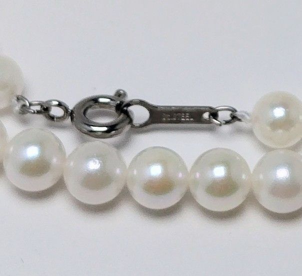 Akoya pearl necklace featuring round 5.5-6.0mm white, green, and pink pearls with good luster