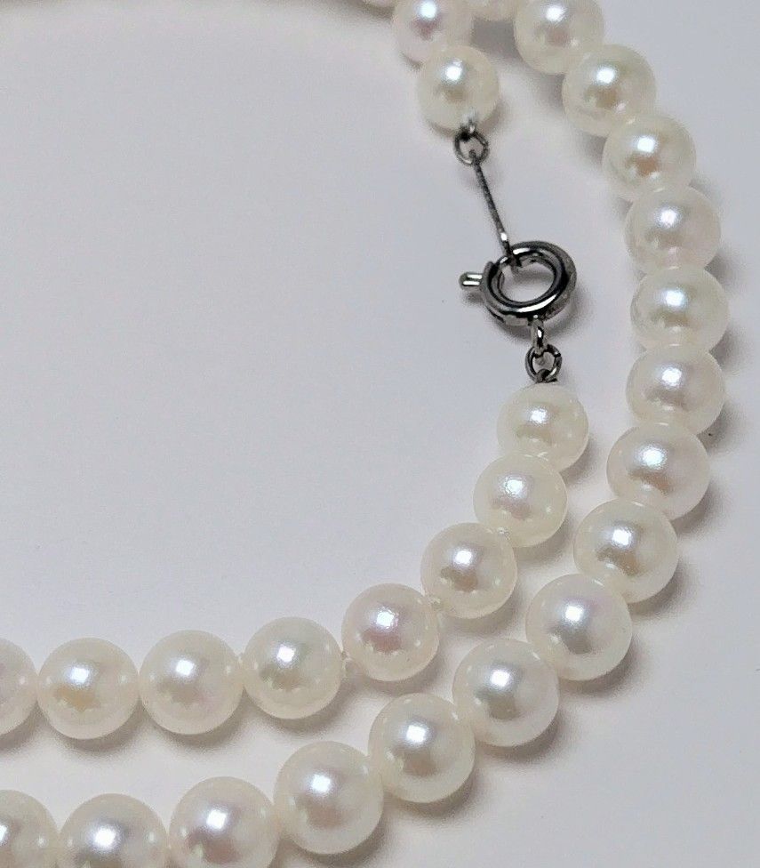 Akoya pearl necklace featuring round 5.5-6.0mm white, green, and pink pearls with good luster