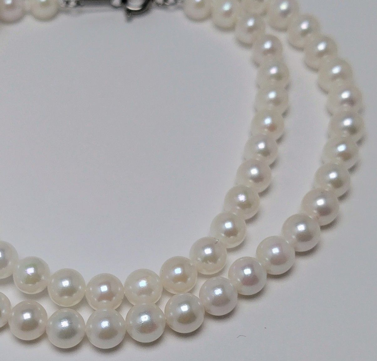 Akoya pearl necklace featuring round 5.5-6.0mm white, green, and pink pearls with good luster