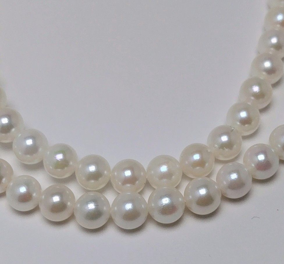 Akoya pearl necklace featuring round 5.5-6.0mm white, green, and pink pearls with good luster