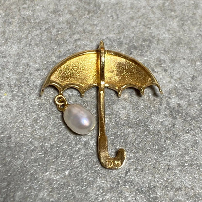 Tasaki necklace top with umbrella motif in K18 yellow gold featuring a pearl, shown in used condition with small scratches