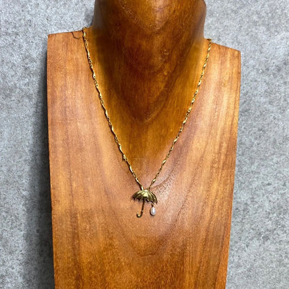 Tasaki necklace top with umbrella motif in K18 yellow gold featuring a pearl, shown in used condition with small scratches