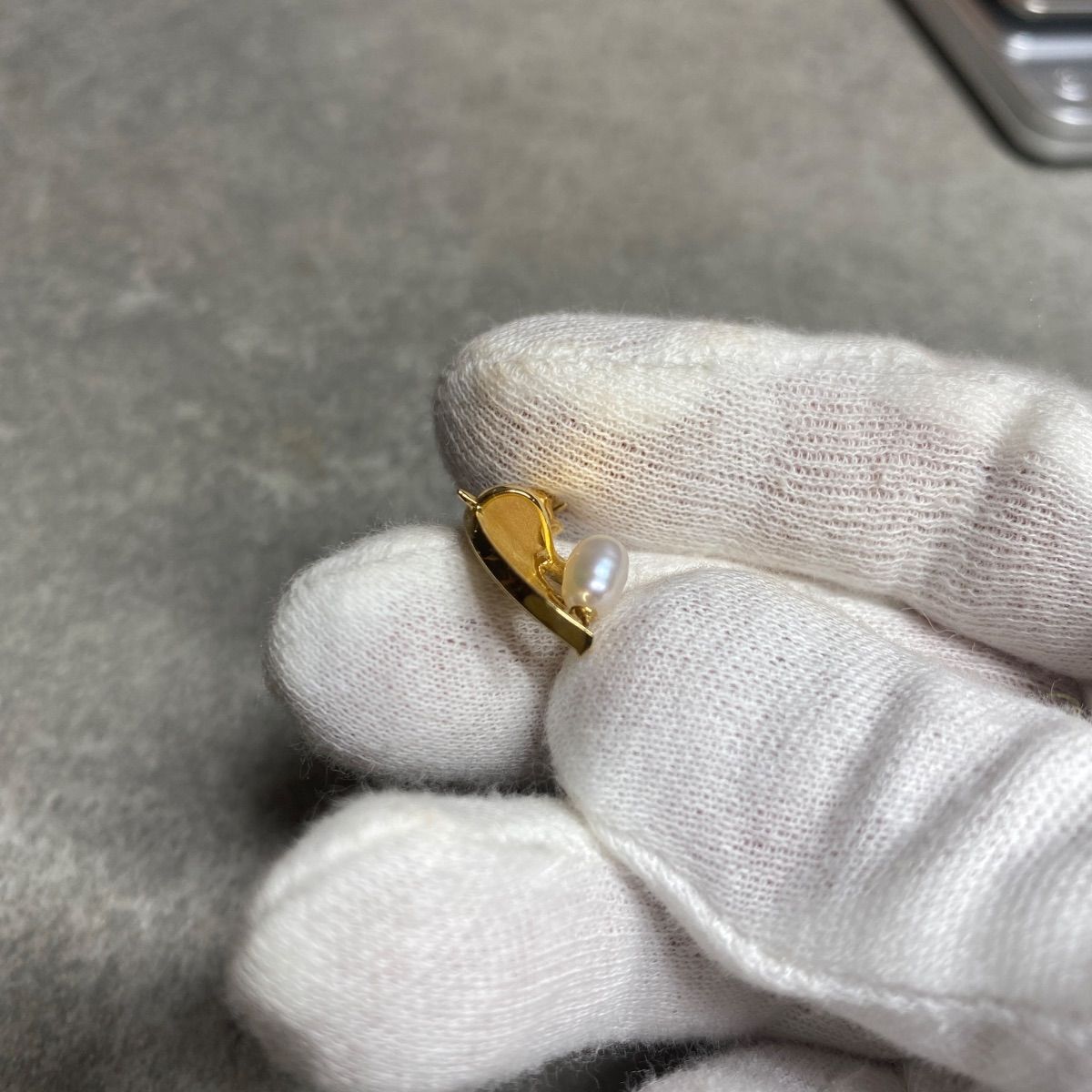 Tasaki necklace top with umbrella motif in K18 yellow gold featuring a pearl, shown in used condition with small scratches
