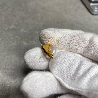 Tasaki necklace top with umbrella motif in K18 yellow gold featuring a pearl, shown in used condition with small scratches