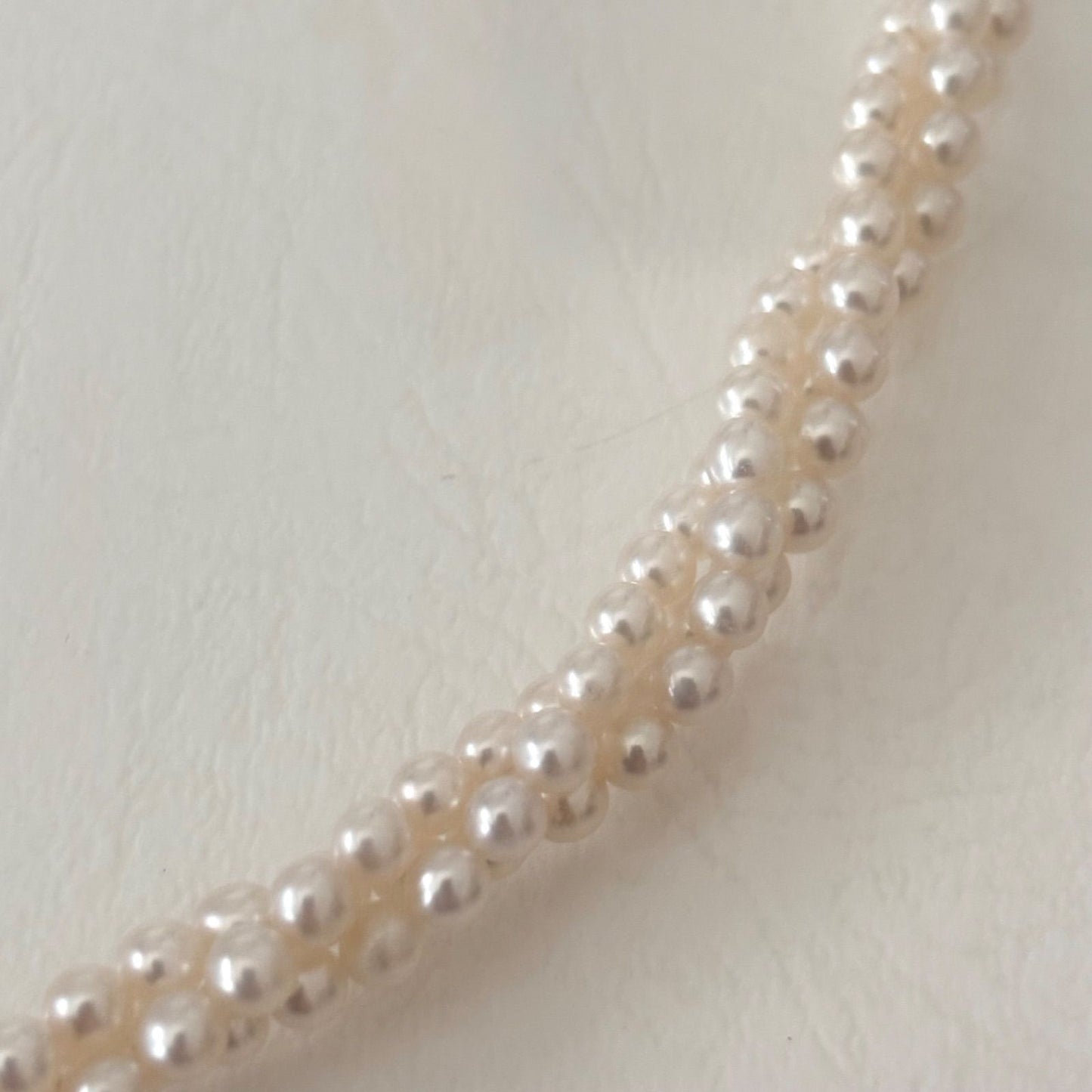 188 Tasaki silver three-row necklace featuring baby pearls and a ribbon clasp, 42.5 cm length