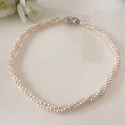 188 Tasaki silver three-row necklace featuring baby pearls and a ribbon clasp, 42.5 cm length