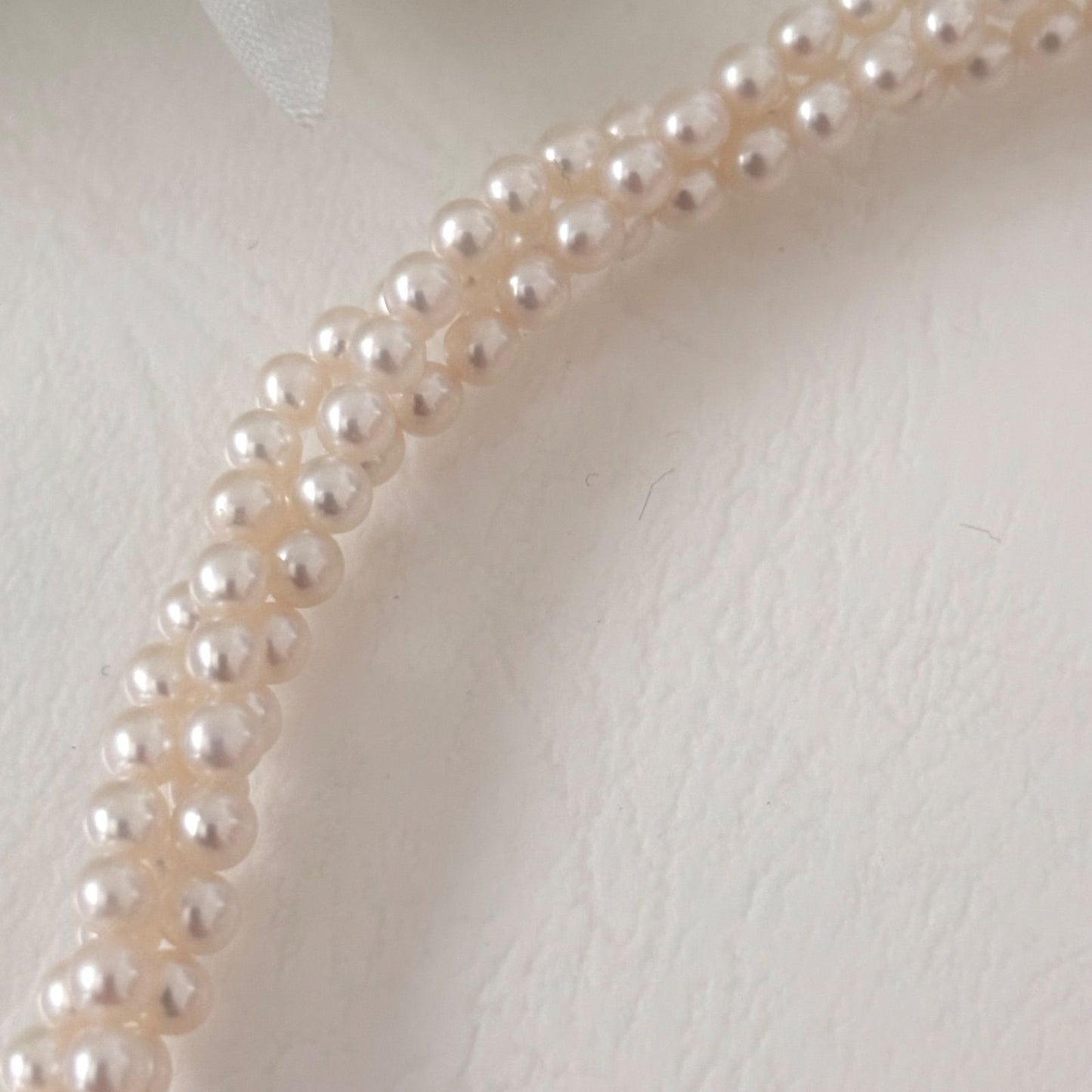 188 Tasaki silver three-row necklace featuring baby pearls and a ribbon clasp, 42.5 cm length