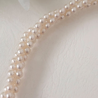 188 Tasaki silver three-row necklace featuring baby pearls and a ribbon clasp, 42.5 cm length