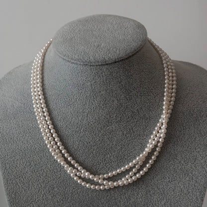 188 Tasaki silver three-row necklace featuring baby pearls and a ribbon clasp, 42.5 cm length