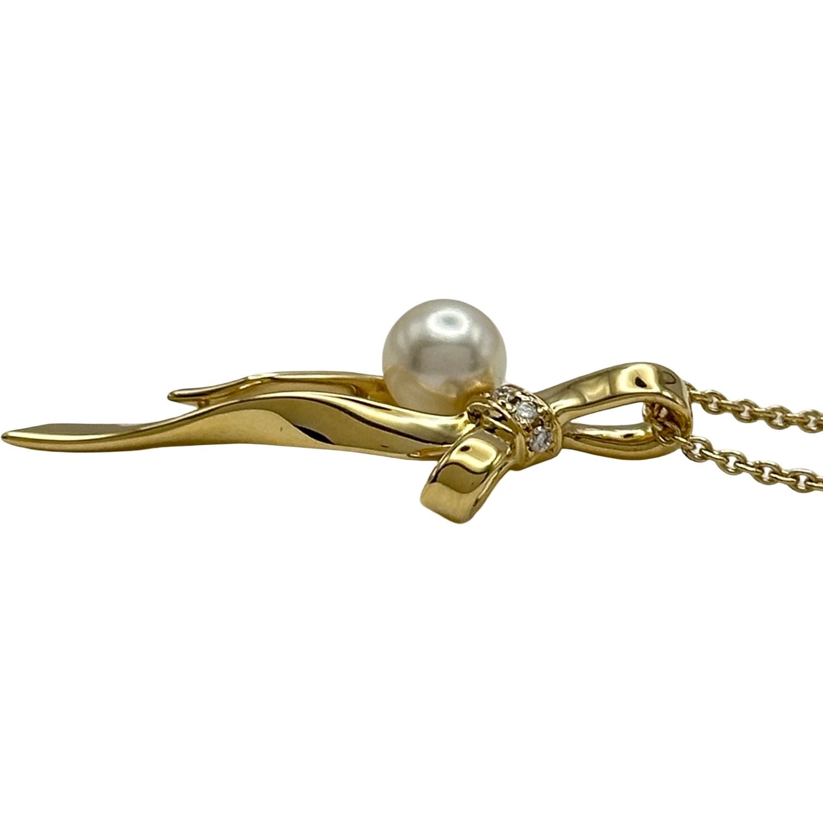Mikimoto gold K18 ribbon necklace with pearl and diamond details on a white background
