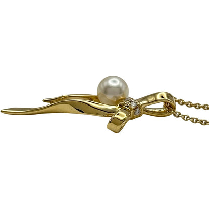 Mikimoto gold K18 ribbon necklace with pearl and diamond details on a white background
