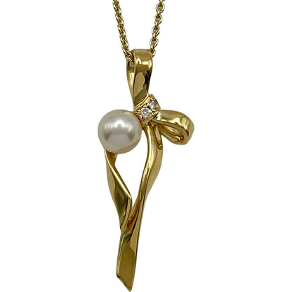 Mikimoto gold K18 ribbon necklace with pearl and diamond details on a white background