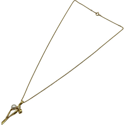 Mikimoto gold K18 ribbon necklace with pearl and diamond details on a white background