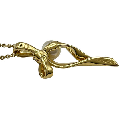 Mikimoto gold K18 ribbon necklace with pearl and diamond details on a white background