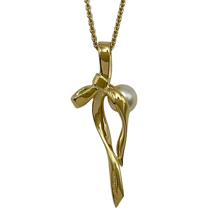 Mikimoto gold K18 ribbon necklace with pearl and diamond details on a white background