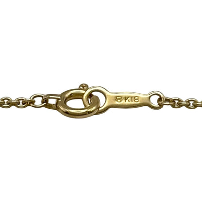 Mikimoto gold K18 ribbon necklace with pearl and diamond details on a white background