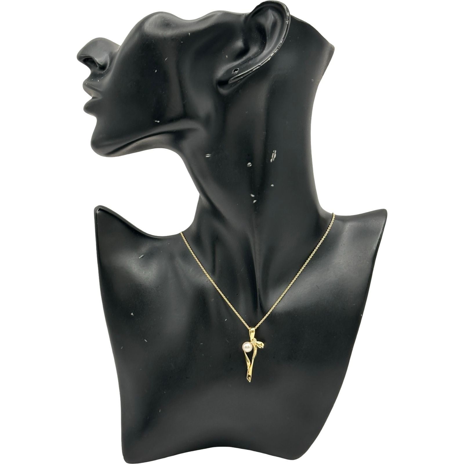 Mikimoto gold K18 ribbon necklace with pearl and diamond details on a white background