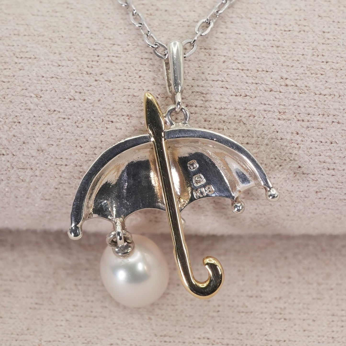 Mikimoto Umbrella Necklace made of silver, K18 gold, and pearl shown on a white background