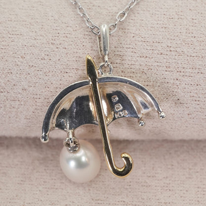Mikimoto Umbrella Necklace made of silver, K18 gold, and pearl shown on a white background