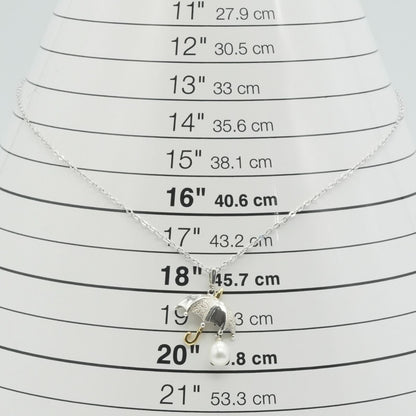 Mikimoto Umbrella Necklace made of silver, K18 gold, and pearl shown on a white background