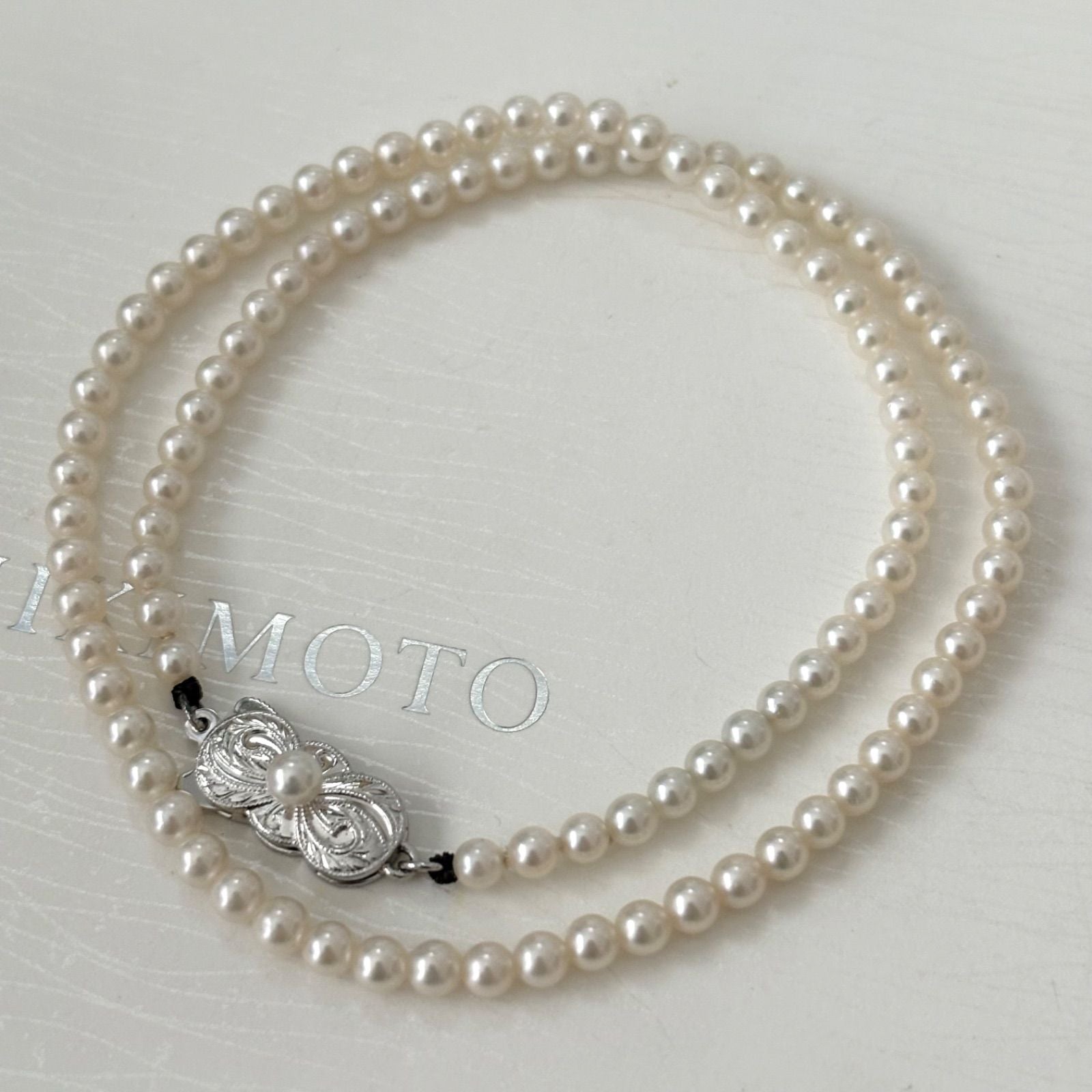 469 Mikimoto silver necklace featuring baby pearls with a 40cm length and silver clasp with minor scratches
