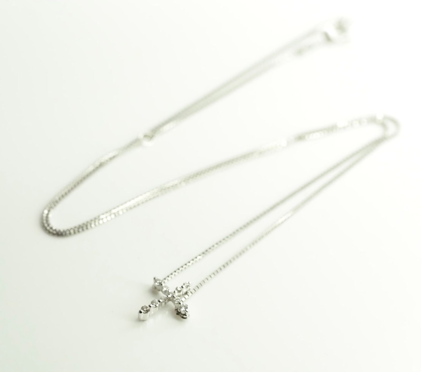 Agete Law K10WG diamond cross necklace in 10 karat white gold with pouch