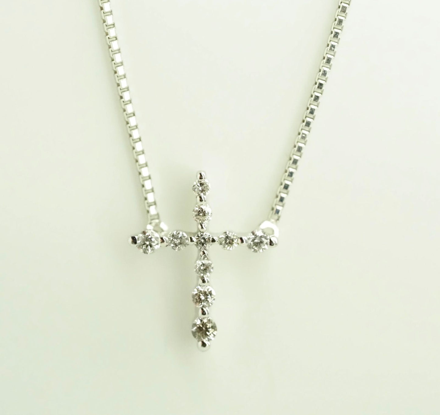 Agete Law K10WG diamond cross necklace in 10 karat white gold with pouch