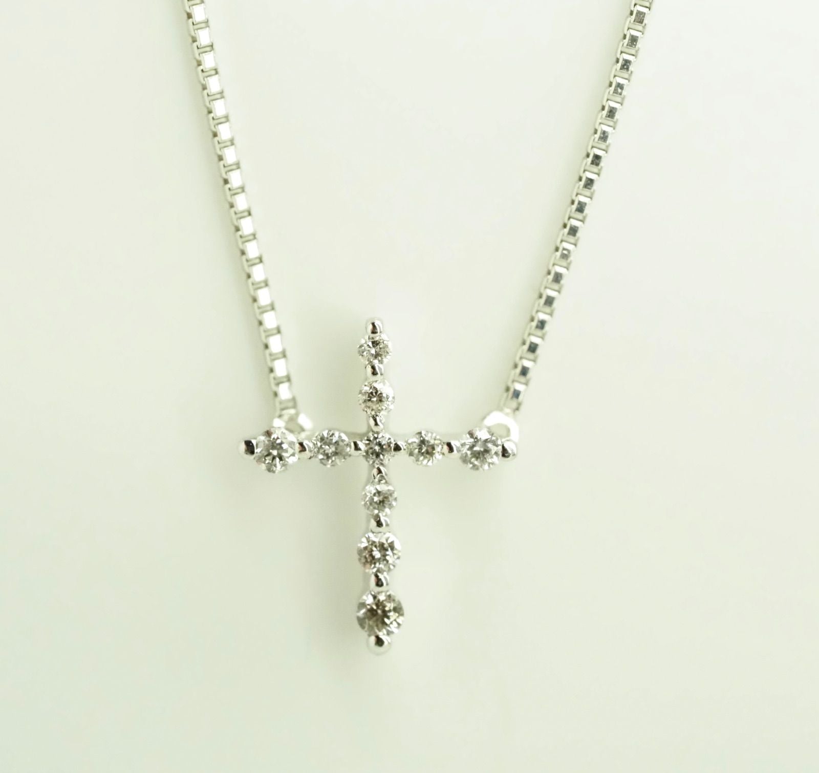 Agete Law K10WG diamond cross necklace in 10 karat white gold with pouch