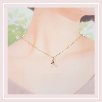 Mikimoto 18K yellow gold pendant necklace with ruby and 5.1mm Akoya pearl on 38cm chain displayed with box