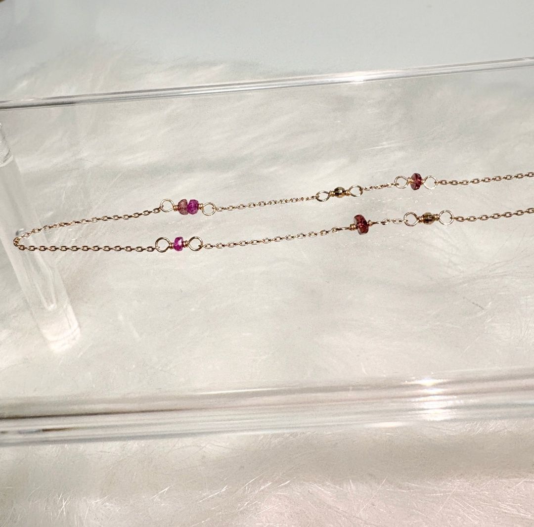 Agete K10 gold necklace with a pink colored stone pendant on a delicate gold chain