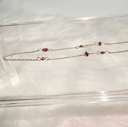 Agete K10 gold necklace with a pink colored stone pendant on a delicate gold chain
