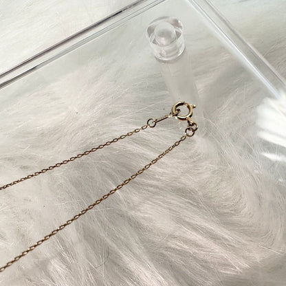 Agete K10 gold necklace with a pink colored stone pendant on a delicate gold chain