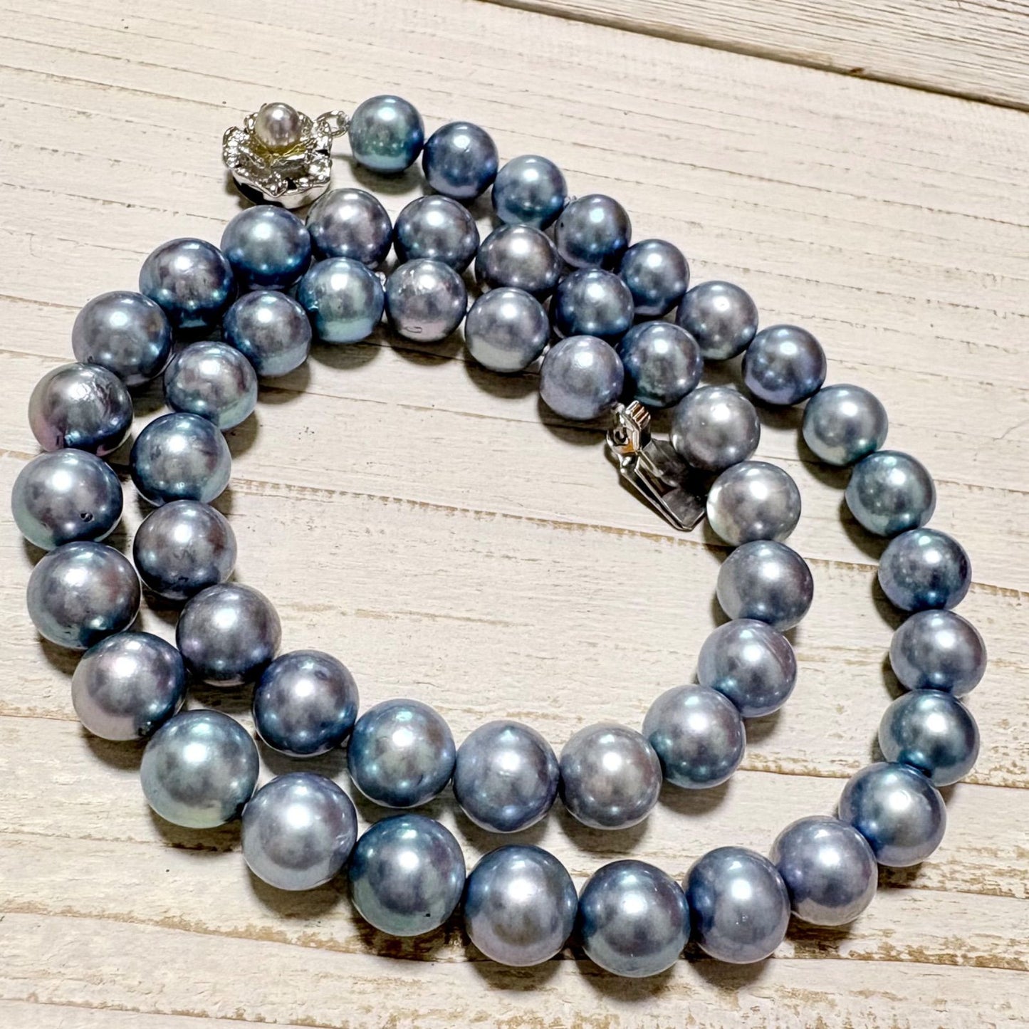 Honmei pearl necklace featuring 8mm blue gray pearls and silver engraved clasp on a white background