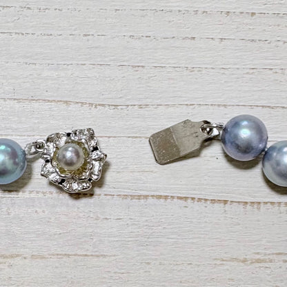 Honmei pearl necklace featuring 8mm blue gray pearls and silver engraved clasp on a white background