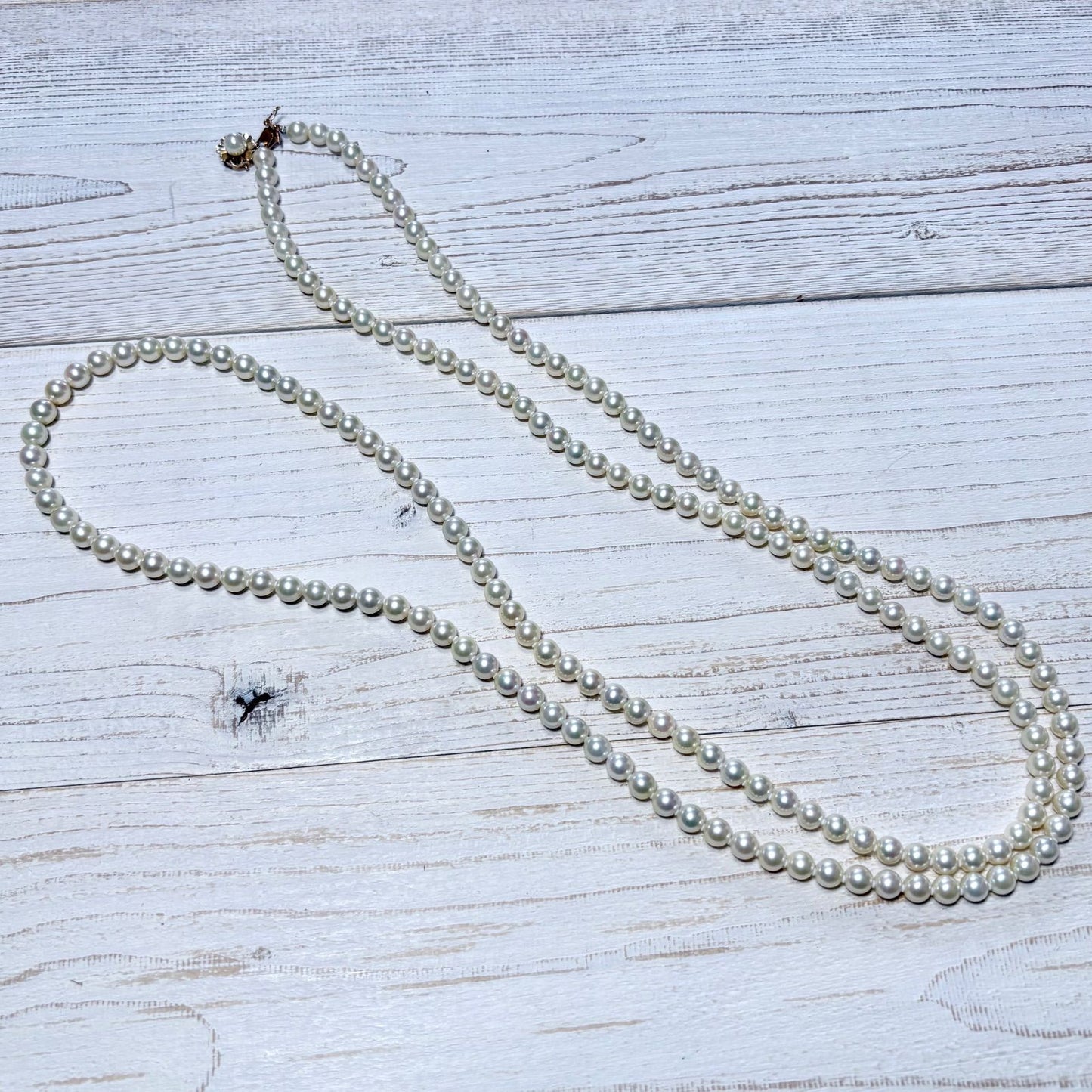 K14 Akoya pearl necklace with 7mm pearls, 127cm long, displayed on a white background