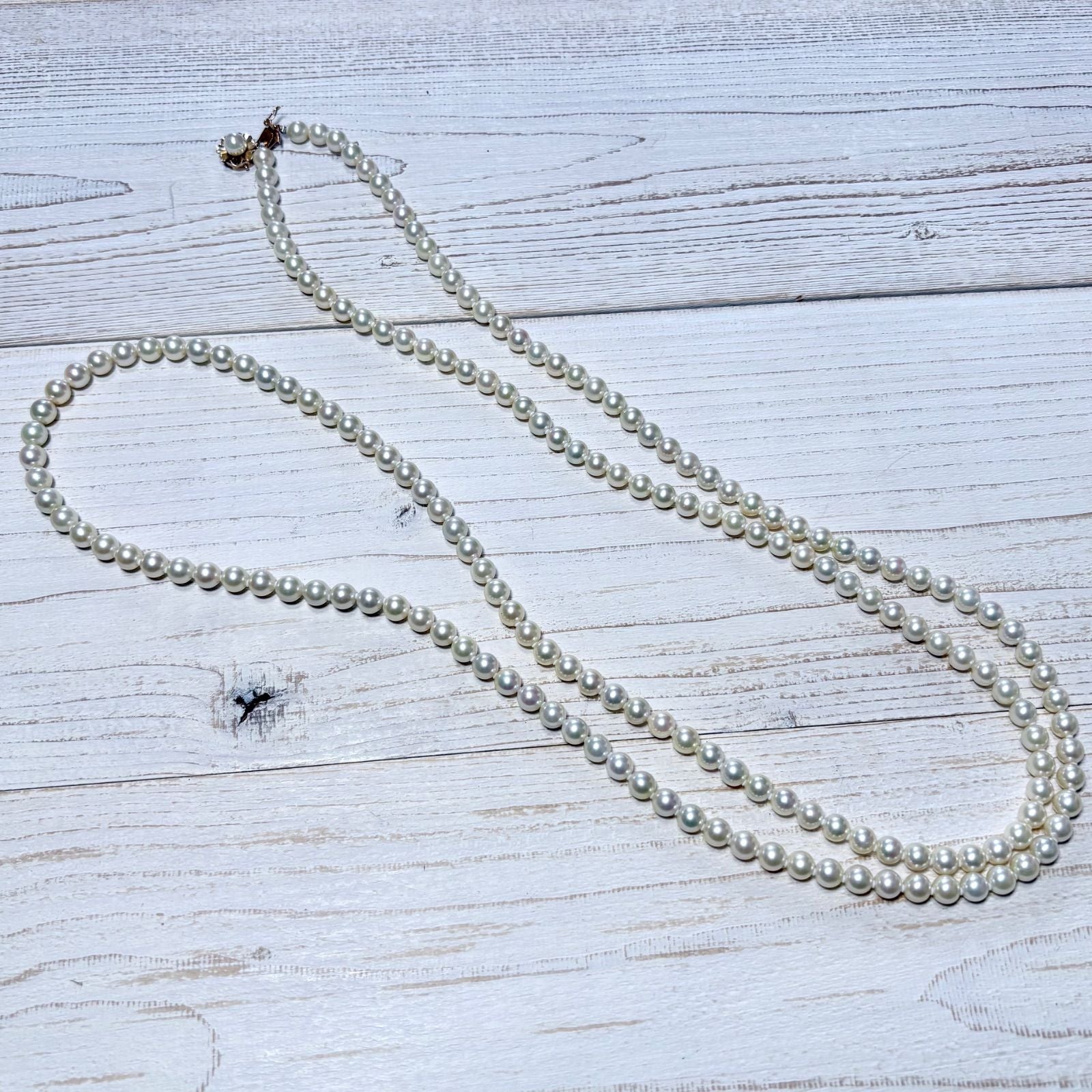 K14 Akoya pearl necklace with 7mm pearls, 127cm long, displayed on a white background