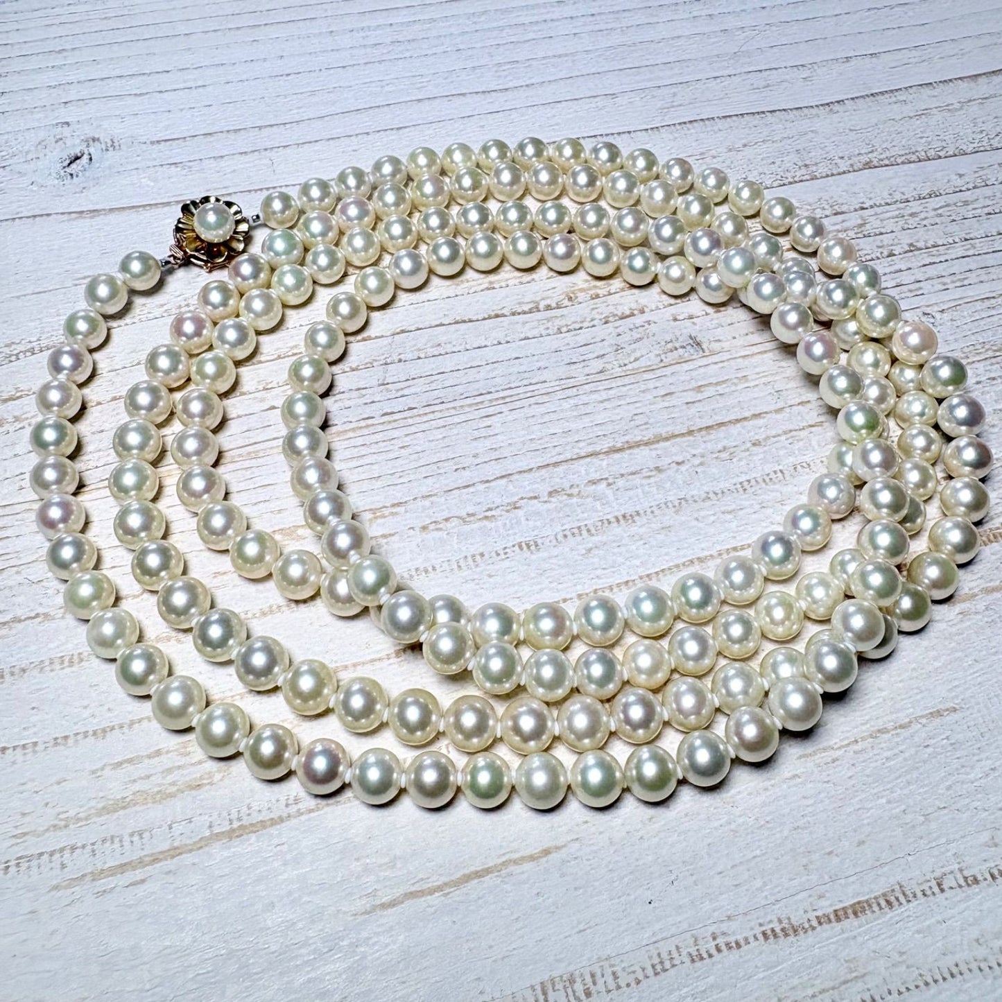 K14 Akoya pearl necklace with 7mm pearls, 127cm long, displayed on a white background