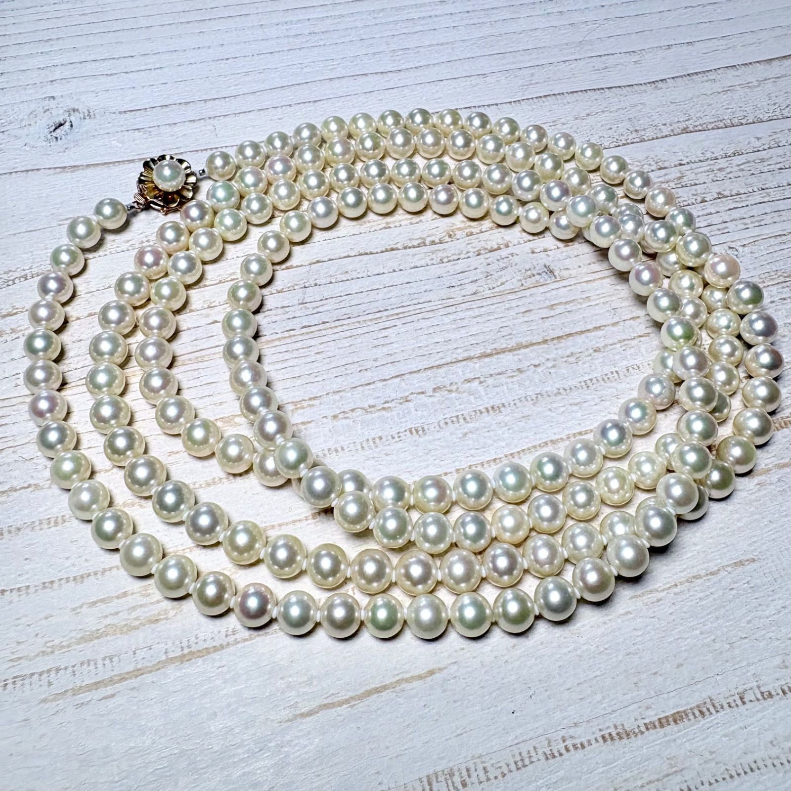 K14 Akoya pearl necklace with 7mm pearls, 127cm long, displayed on a white background