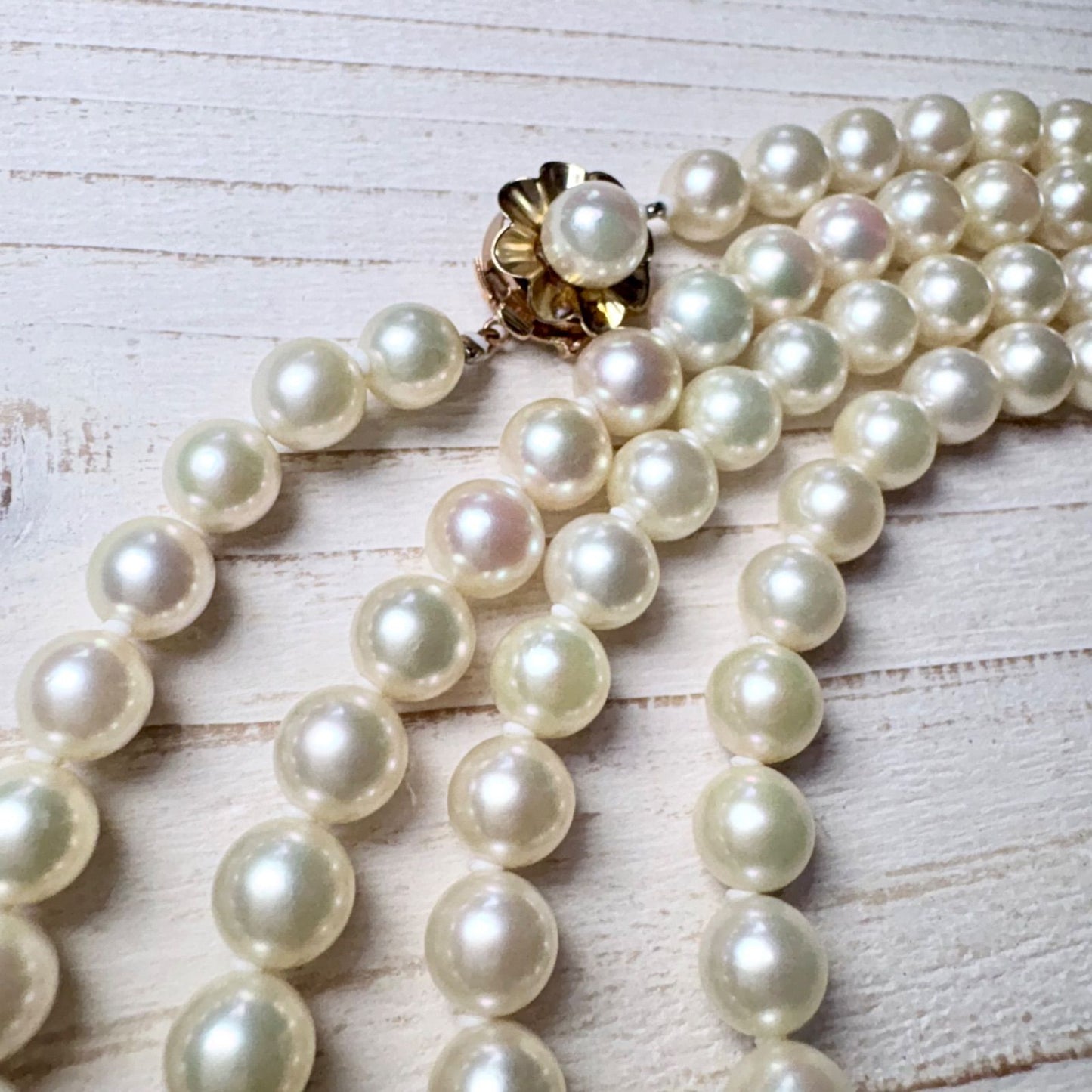 K14 Akoya pearl necklace with 7mm pearls, 127cm long, displayed on a white background