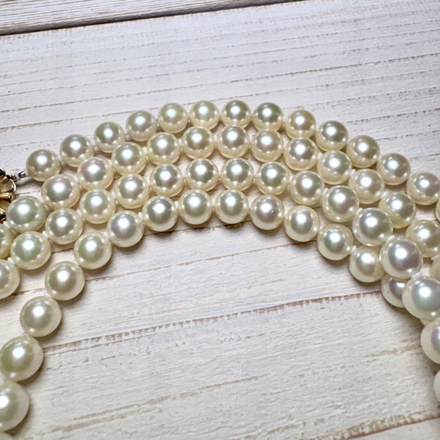 K14 Akoya pearl necklace with 7mm pearls, 127cm long, displayed on a white background