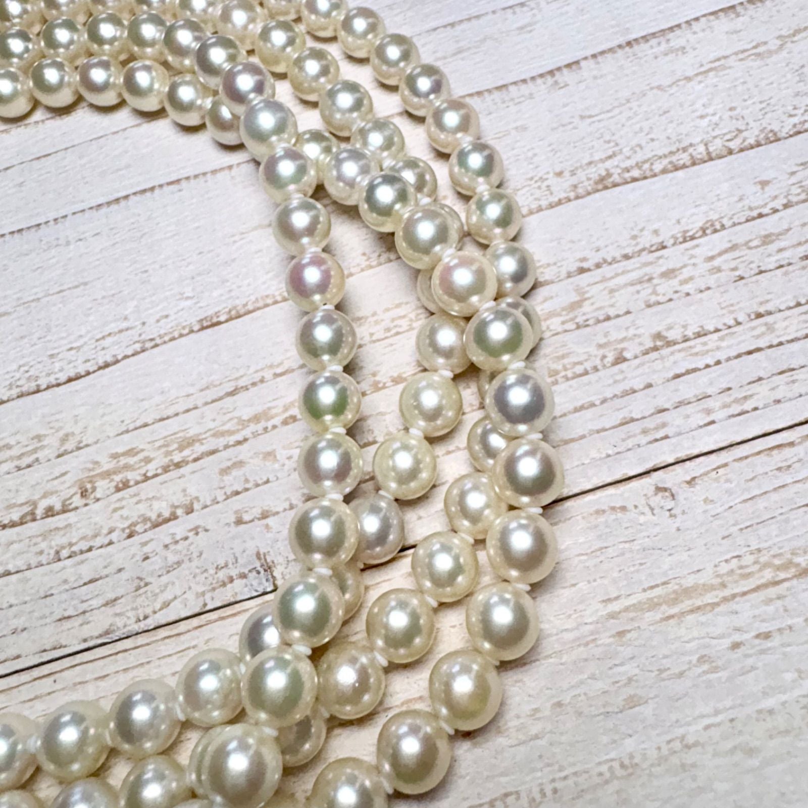 K14 Akoya pearl necklace with 7mm pearls, 127cm long, displayed on a white background