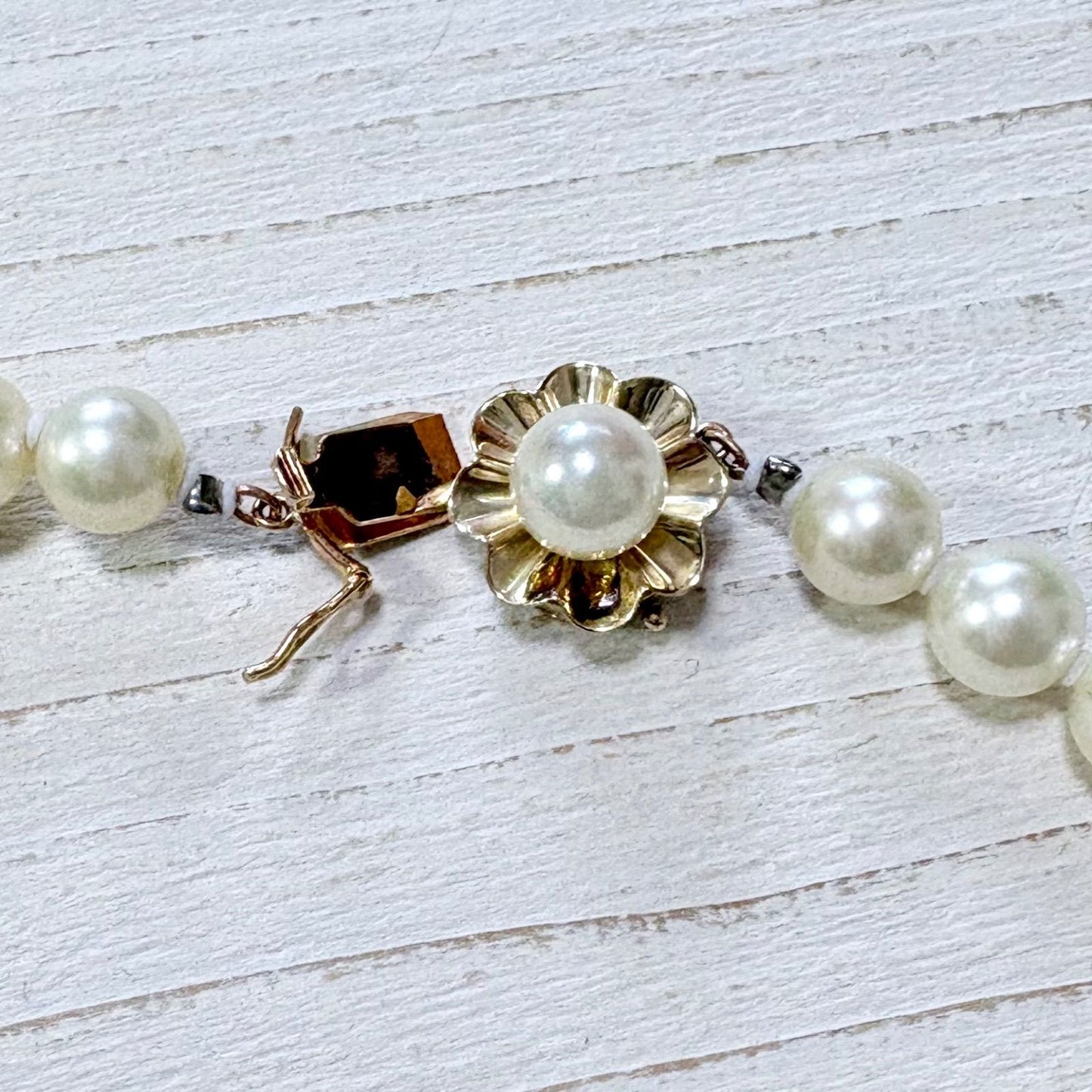 K14 Akoya pearl necklace with 7mm pearls, 127cm long, displayed on a white background