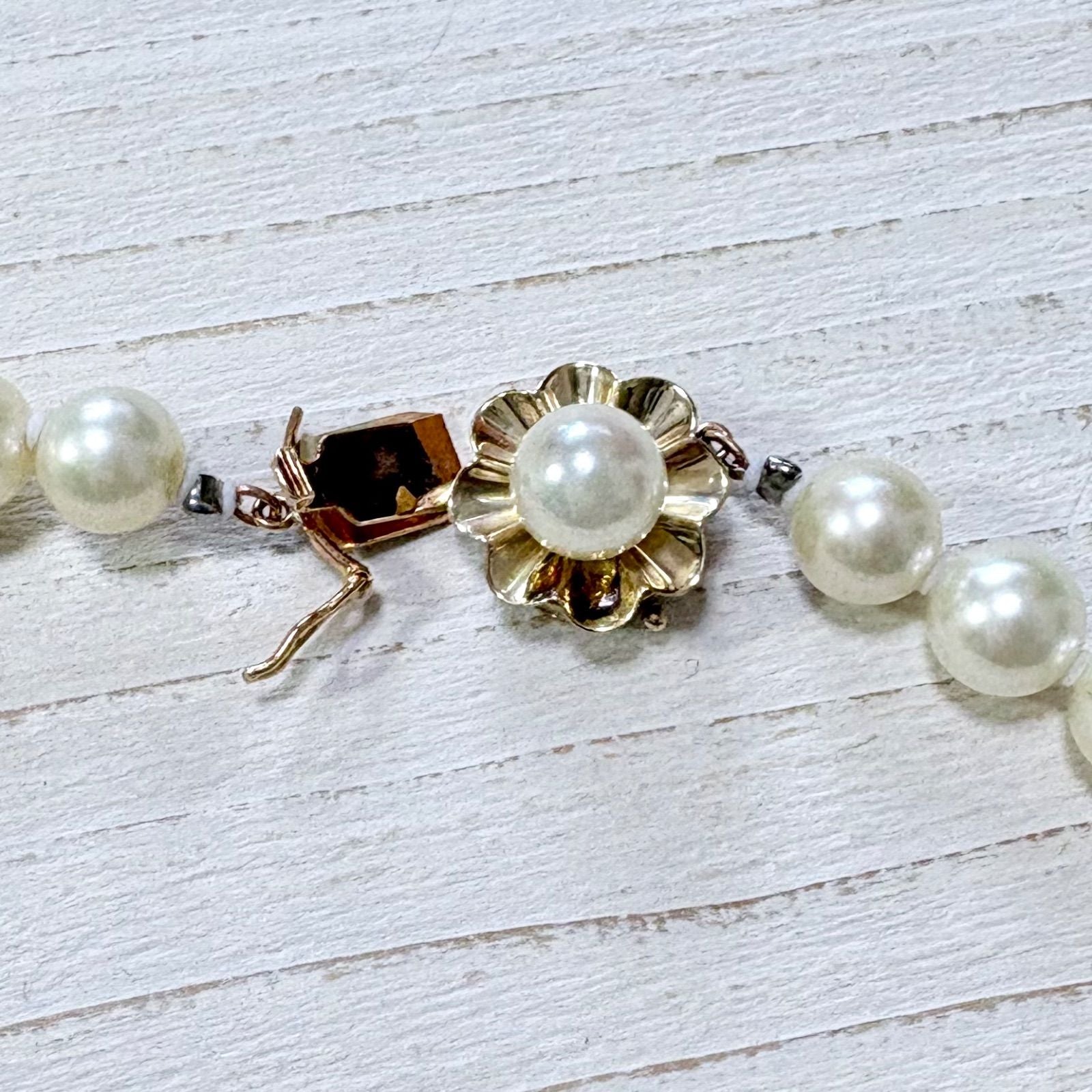 K14 Akoya pearl necklace with 7mm pearls, 127cm long, displayed on a white background